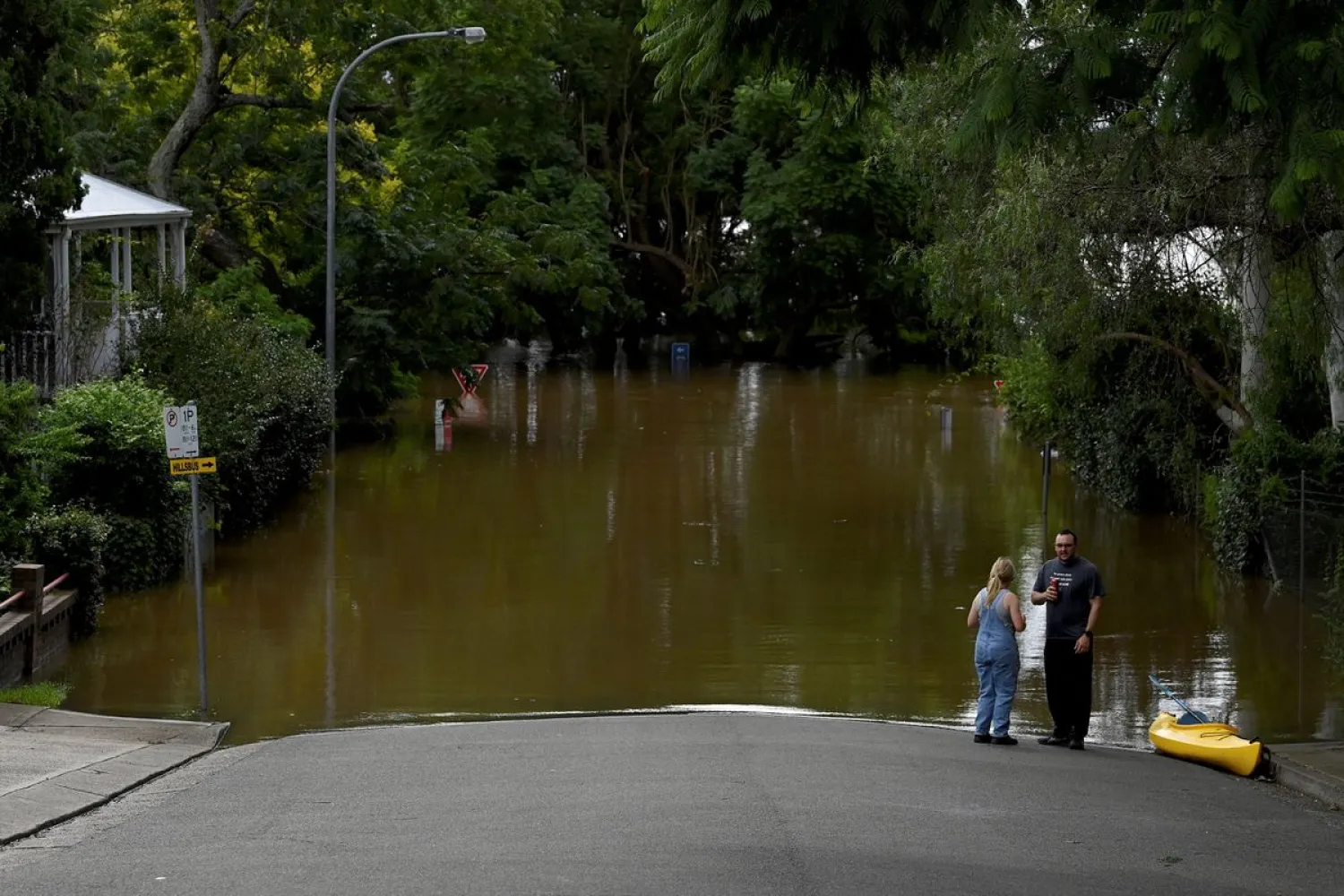 People look on as residential properties and roads are submerged under floodwater in Windsor, north-west of Sydney, Australia. Reuters file photo

