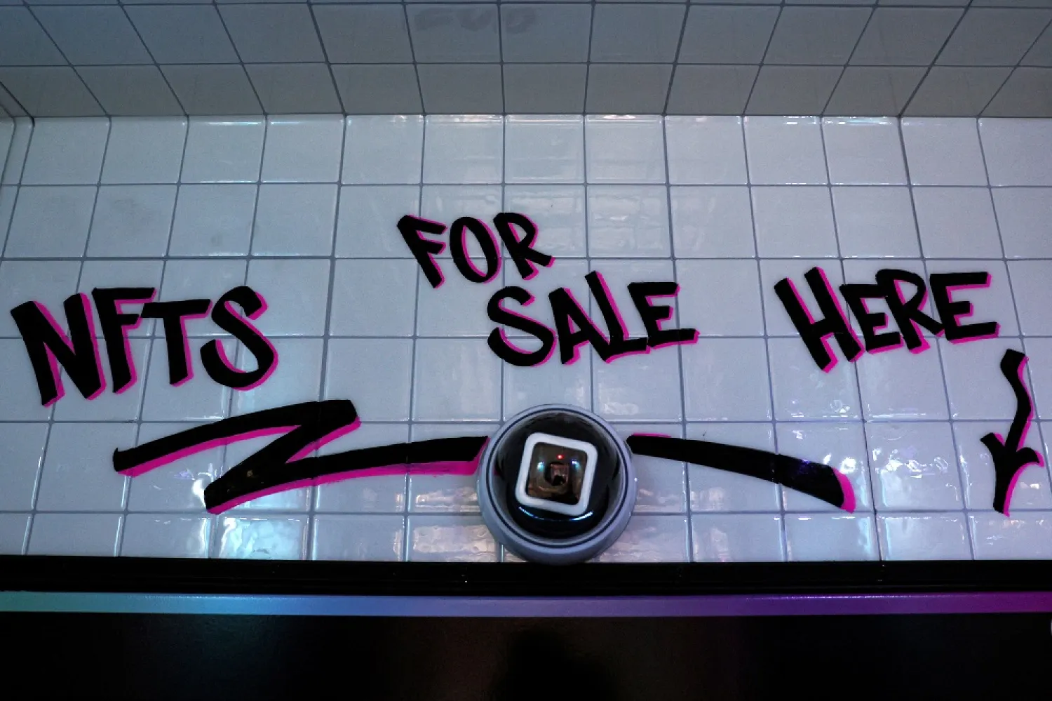 A sign saying "NFT FOR SALE HERE," is seen in a small storefront that hosts digital art collecting platform Neon's first in-person non-fungible token (NFT) vending machine in Lower Manhattan's financial district of New York City, US, March 1, 2022. (Reuters)