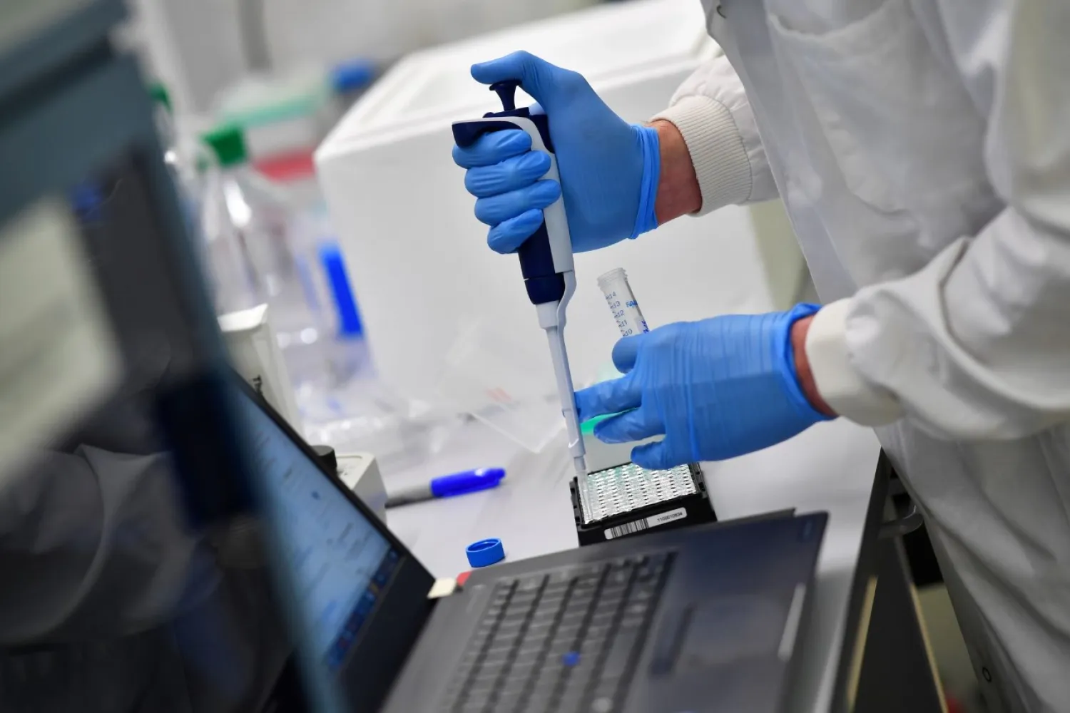 Scientists work at a laboratory south of Cambridge, Britain, March 12, 2021. REUTERS/Dylan Martinez