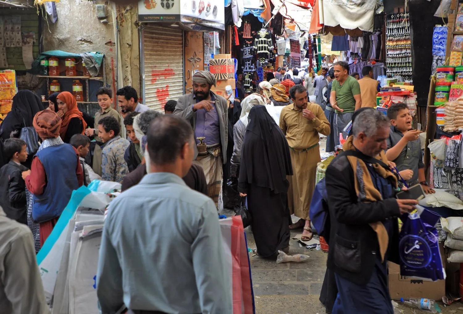 Yemenis shop at a market in the capital Sanaa on July 6, 2022, as Muslims prepare for the Eid al-Adha holiday. (AFP) 