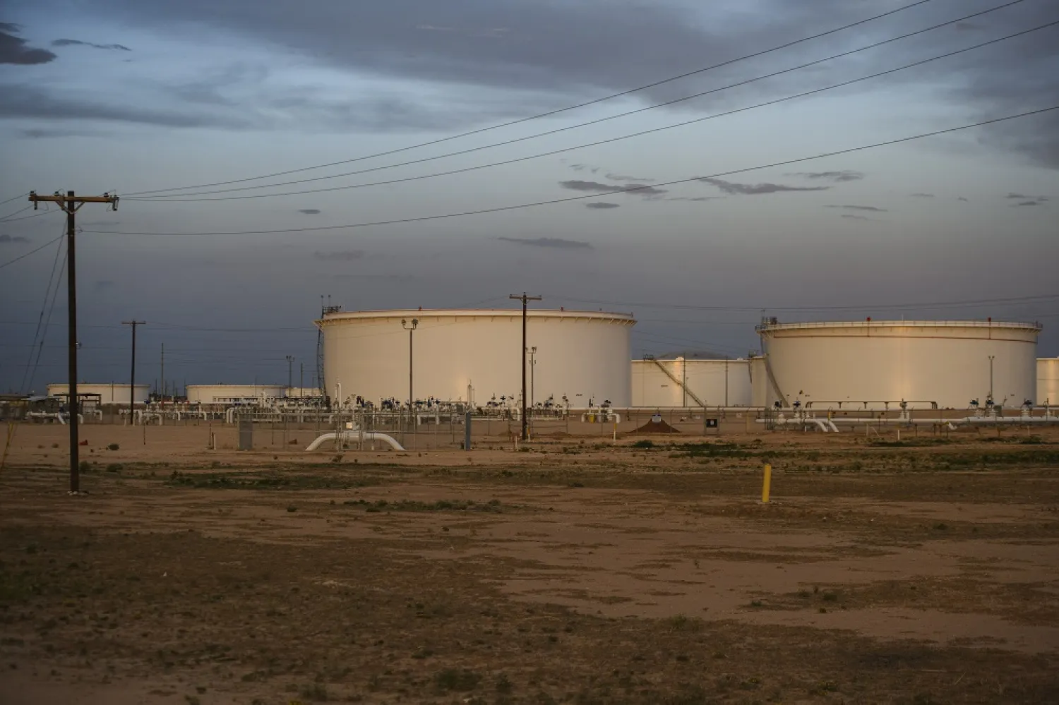 A portion of a crude oil battery that makes up a portion of the national crude oil reserve is seen pictured as blue hour begins to take over Tuesday, July 5, 2022 in Midland, Texas. (AP) 