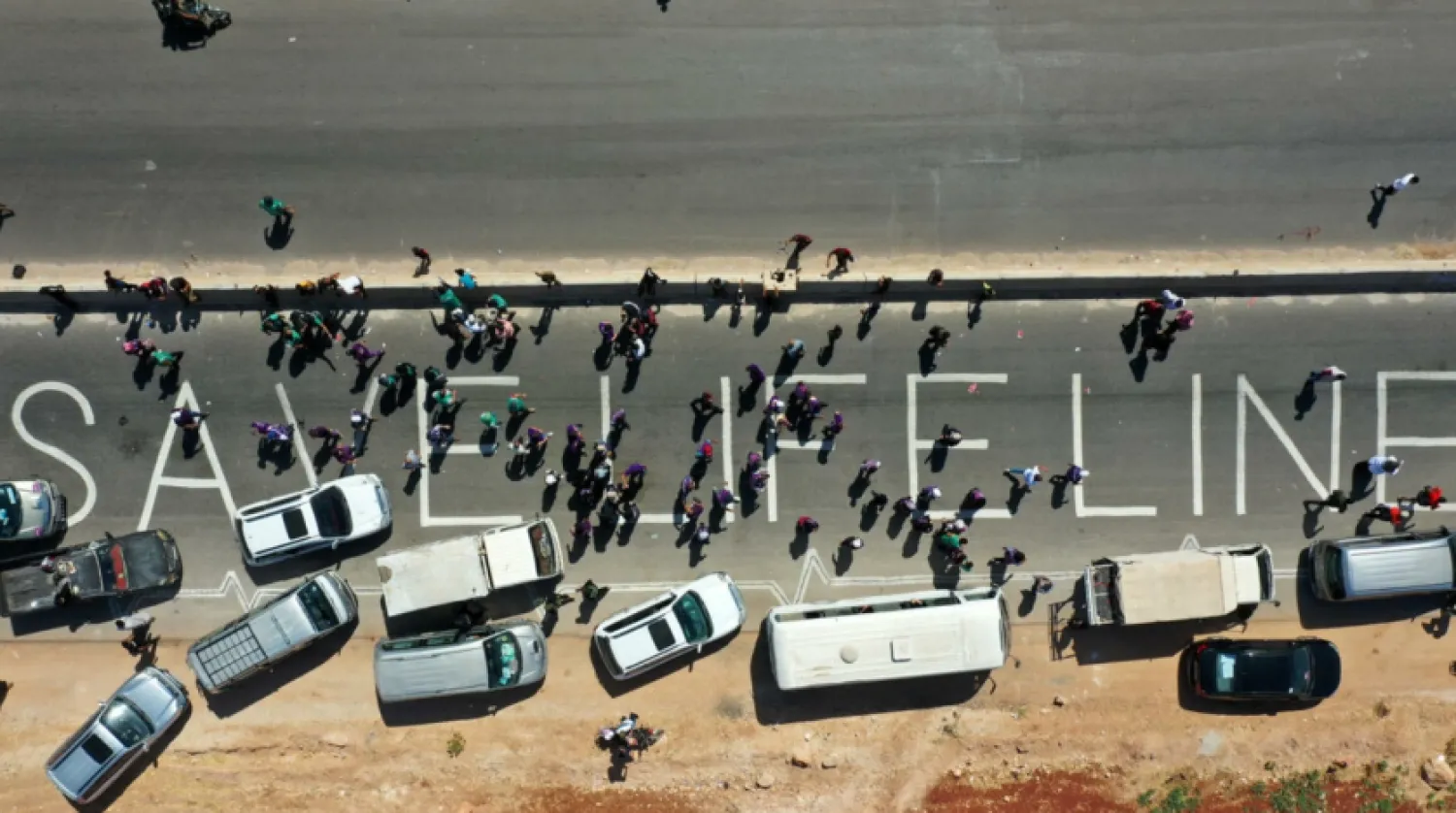 A human chain calling the continued passage of aid into Syria's opposition-held northwestern province of Idlib, seen here in this photograph from July 2, 2021 Omar HAJ KADOUR AFP
