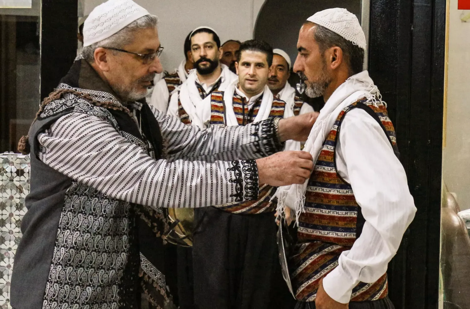 Moutaz Boulad (L), leader of the "Bab al-Hara" traditional Syrian "Arada" dance troupe, assists members as they gear up to perform Khalil MAZRAAWI AFP
