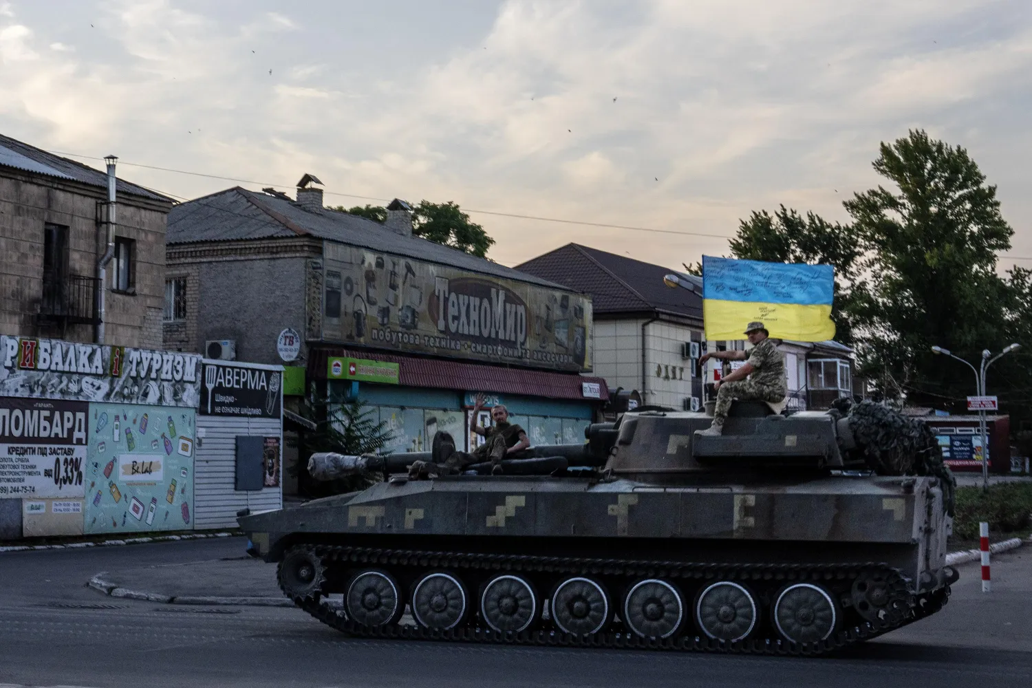 Ukrainian soldiers ride atop a tank through a street in Pokrovsk, Donetsk region, eastern Ukraine, Friday, July 8, 2022. (AP Photo/Nariman El-Mofty)
