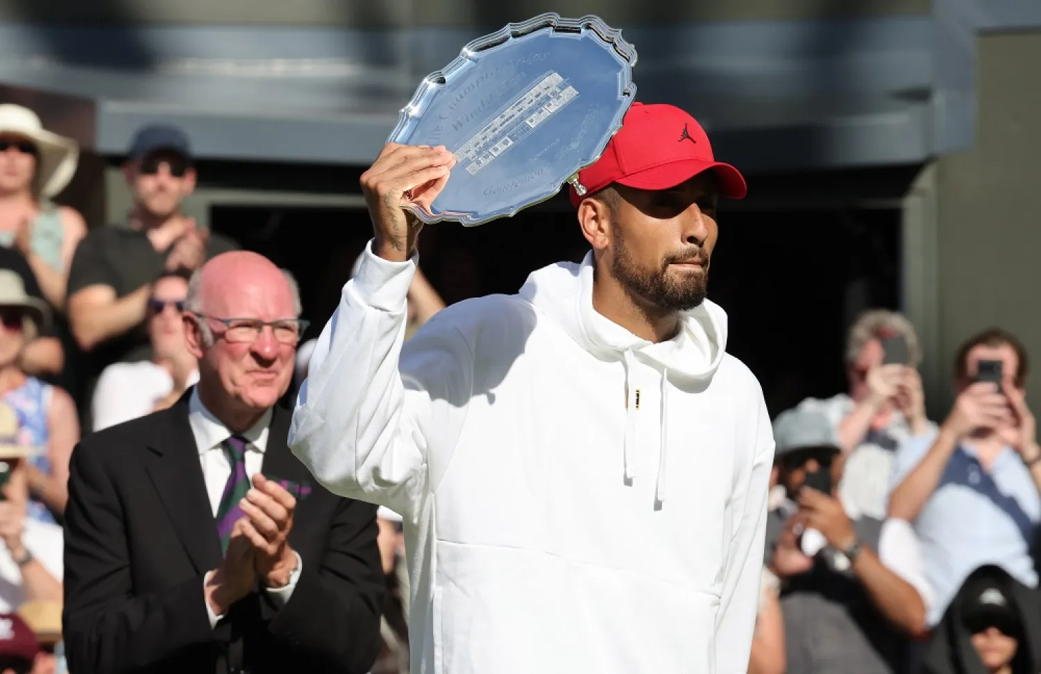 Nick Kyrgios of Australia poses with the runner-up trophy after the men's final match against Novak Djokovic of Serbia at the Wimbledon Championships, in Wimbledon, Britain, 10 July 2022. (EPA)