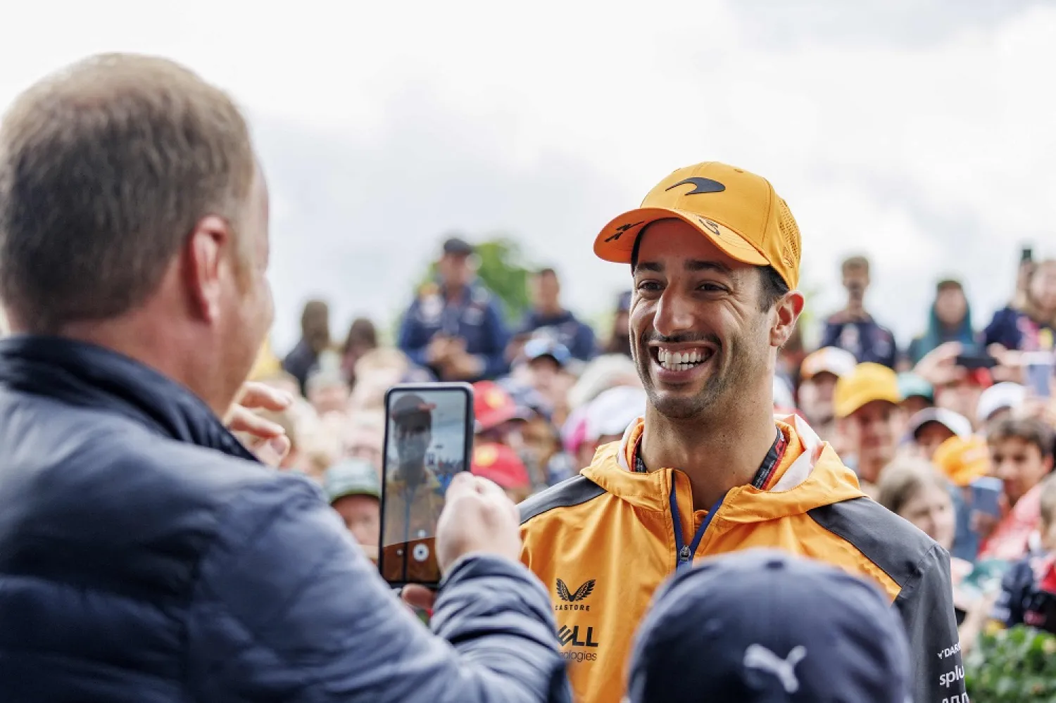 McLaren's Australian driver Daniel Ricciardo (R) poses for a photo at the Styrian Green Carpet near the Red Bull Ring race track in Spielberg, Austria, on July 10, 2022, ahead of the Formula One Austrian Grand Prix. (AFP)