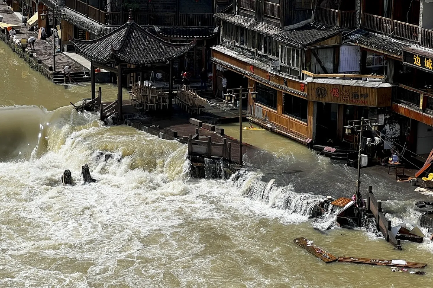 Flood waters sweep through the ancient town of Feng Huang in central China's Hunan province, Saturday, June 4, 2022. (AP)