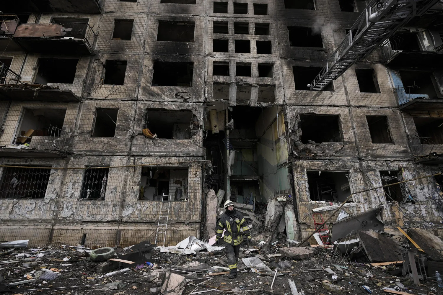 A Ukrainian firefighters works in an apartment building after it was hit by artillery shelling in Kyiv, Ukraine, Monday, March 14, 2022. (AP Photo/Vadim Ghirda)

