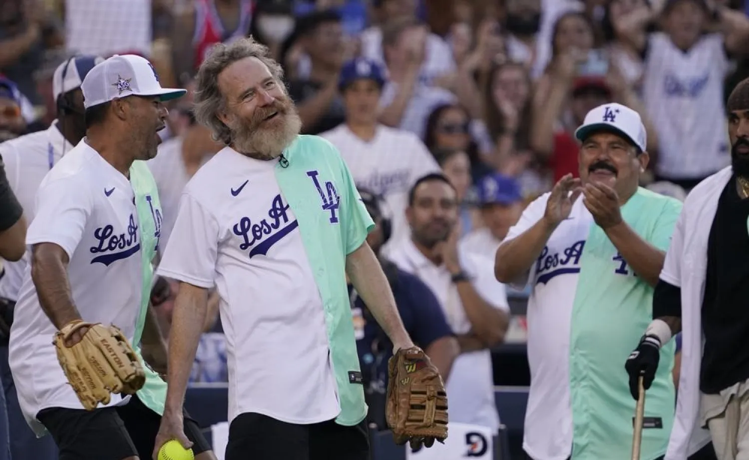Actor Bryan Cranston smiles after catching a foul ball during the MLB All Star Celebrity Softball game, Saturday, July 16, 2022, in Los Angeles. (AP)