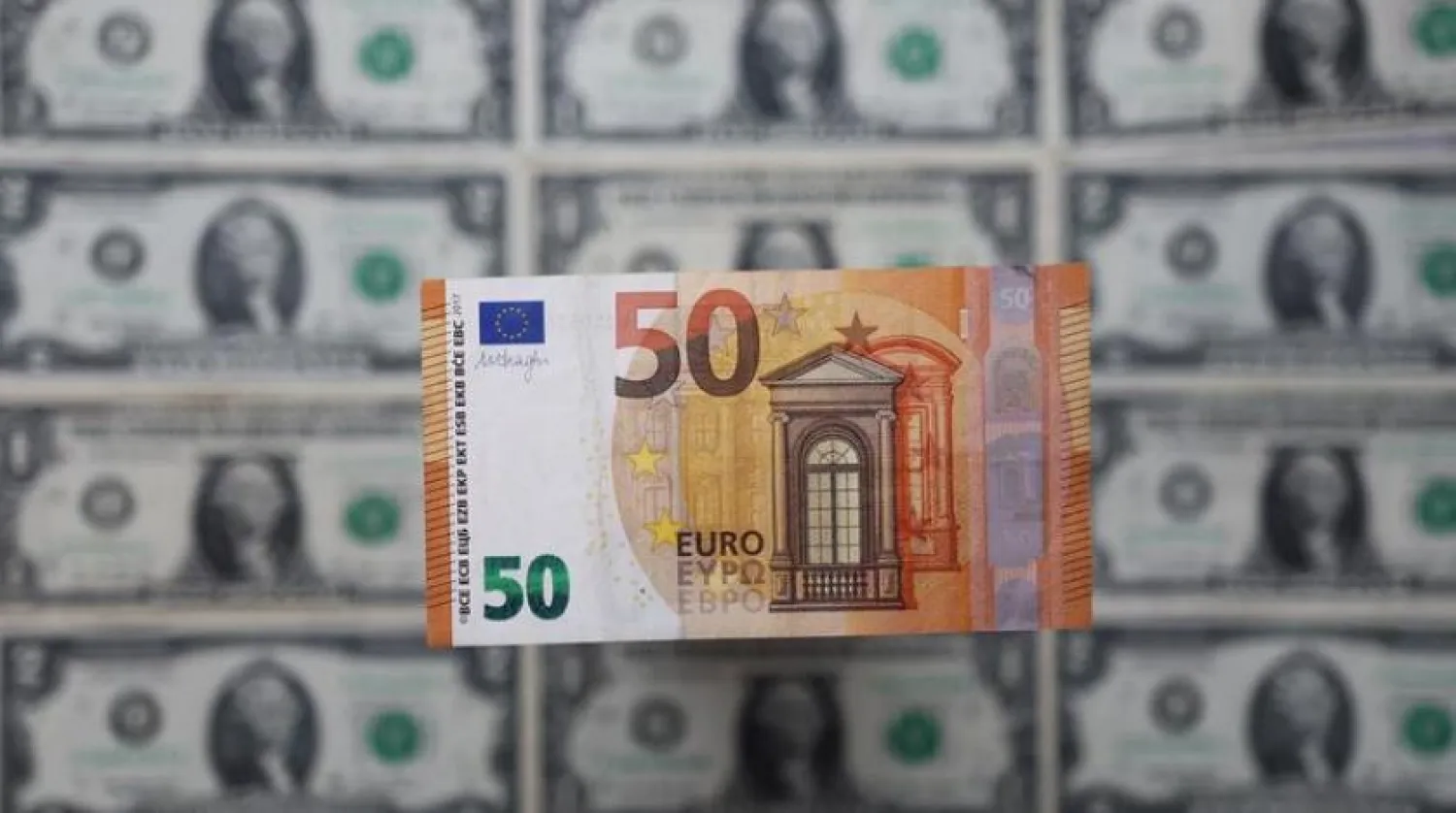 A Euro banknote is displayed on US Dollar banknotes in this illustration taken, February 14, 2022. REUTERS/Dado Ruvic/Illustration
