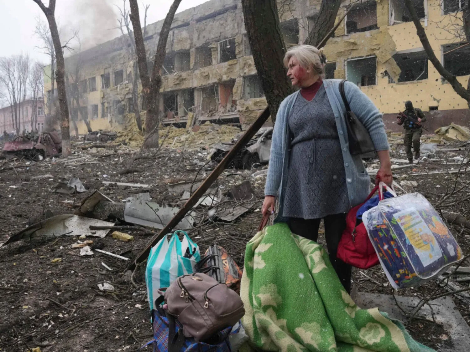 A woman walks outside a children's hospital in Mariupol, Ukraine, which was hit by a Russian air strike on Wednesday, March 9, 2022. Evgeniy Maloletka, AP

