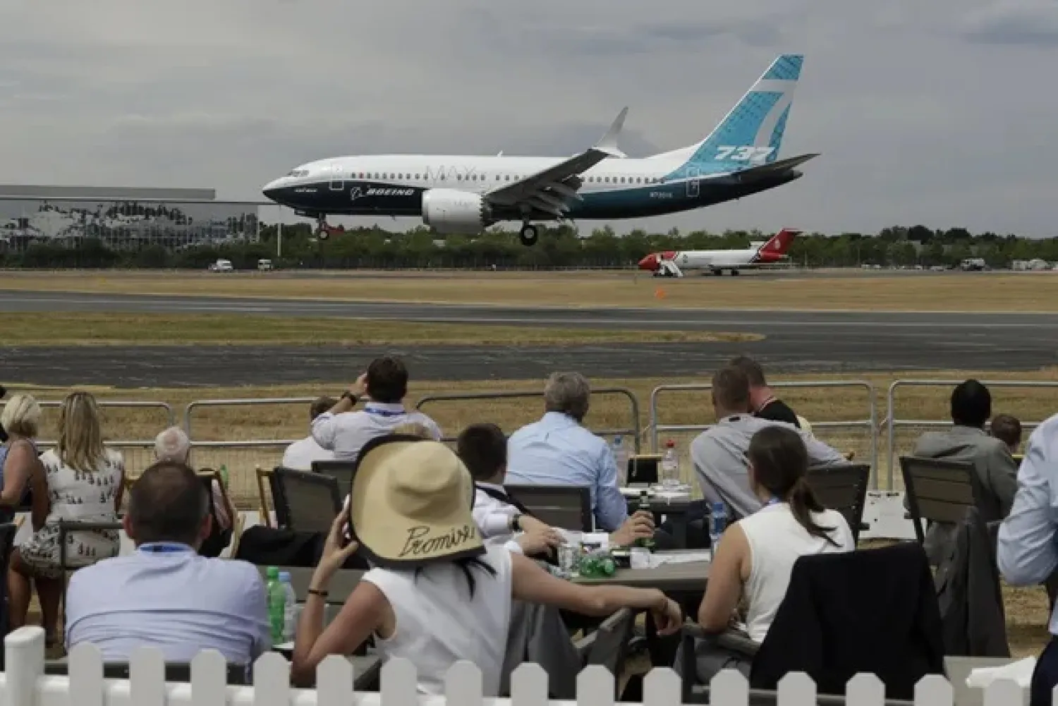 Spectators watch a Boeing 737 land after a flying display at the Farnborough Airshow in Farnborough, England, Monday, July 16, 2018. (AP Photo/Matt... (Matt Dunham / The Associated Press)
