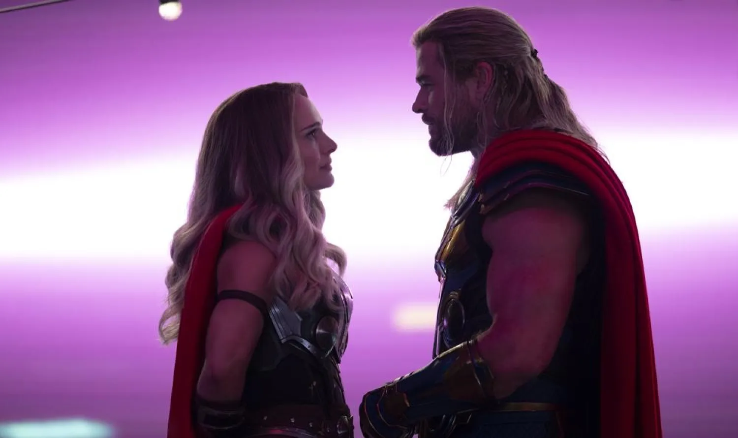 This image released by Marvel Studios shows Natalie Portman, left, and Chris Hemsworth in a scene from "Thor: Love and Thunder." (Marvel Studios-Disney via AP)