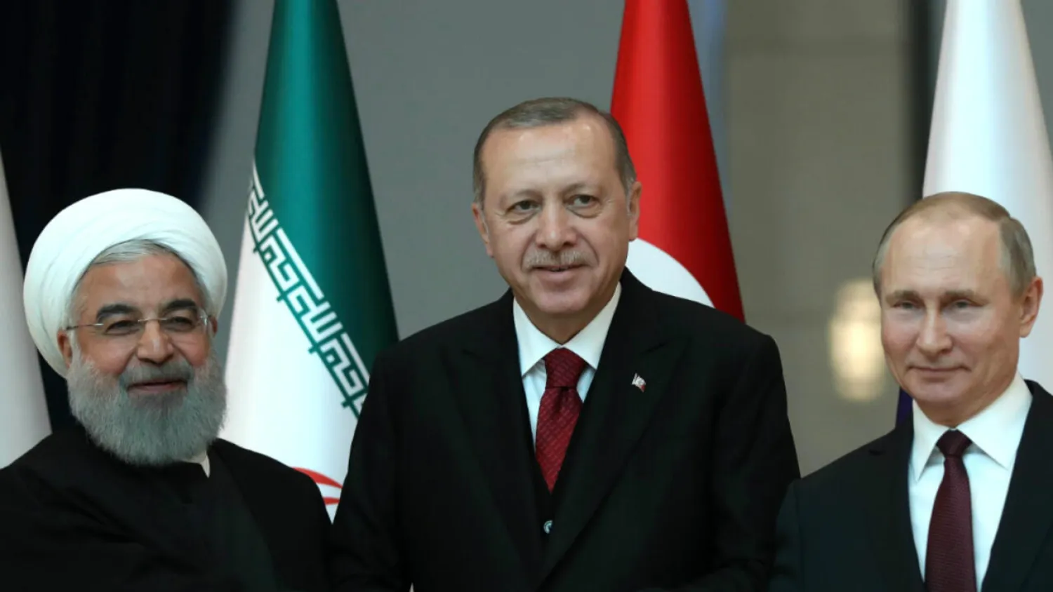 Tolga Bozoglu, AFP archive | Iran's Hassan Rouhani, Turkish President Recep Tayyip Erdogan, Russian President Vladimir Putin and at a tripartite summit in Ankara, Turkey in April 2018.
