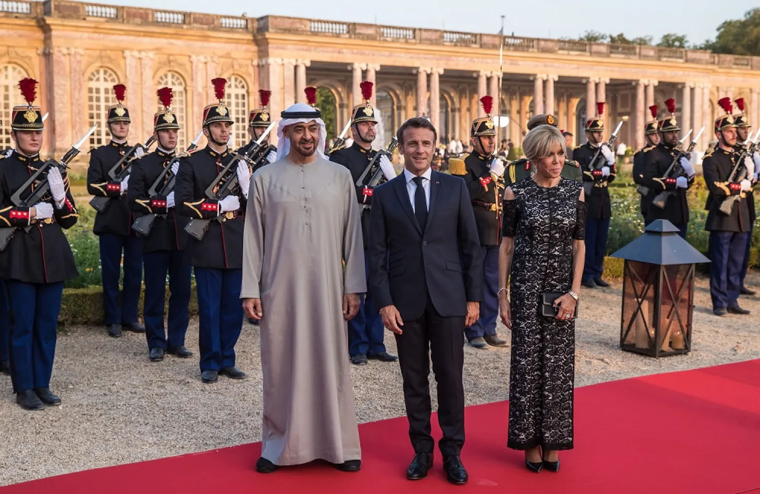 President Emmanuel Macron (C) and his wife Brigitte Macron (R) pose for photographs with UAE President Sheikh Mohamed bin Zayed Al Nahyan (L) prior to a state dinner held at the Grand Trianon of the Versailles castle near Paris, France, 18 July 2022. (EPA)