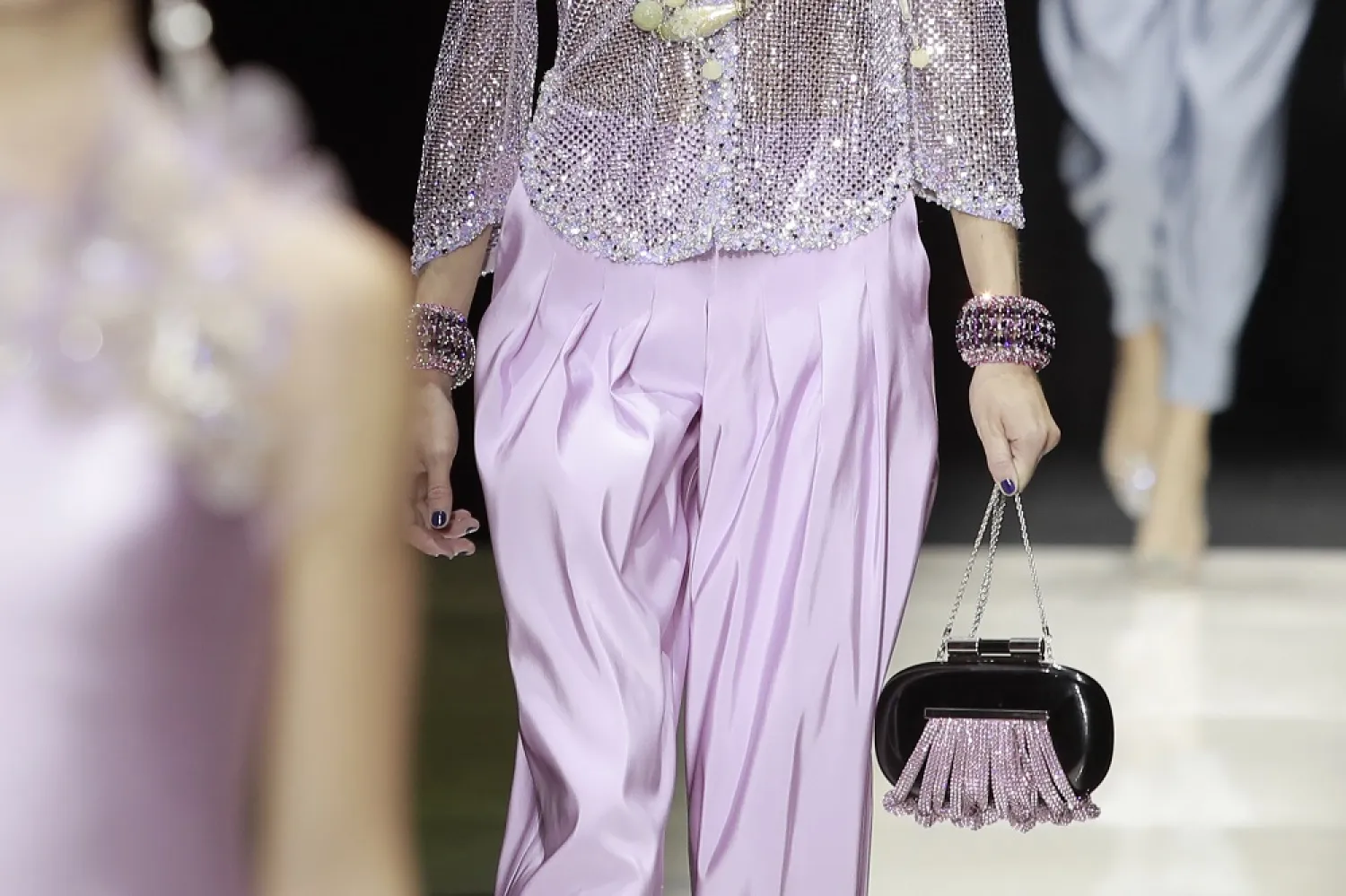 A model carries a handbag as part of Giorgio Armani Privé's Haute Couture Fall/Winter 2022-2023 fashion collection presented Tuesday, July 5, 2022 in Paris. (AP)