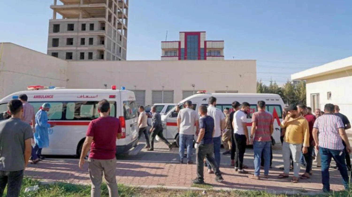 People gather outside a hospital following Turkish shelling in the city of Zakho in the north of Iraq's autonomous Kurdish region on July 20, 2022. (Photo by Ismael ADNAN / AFP)