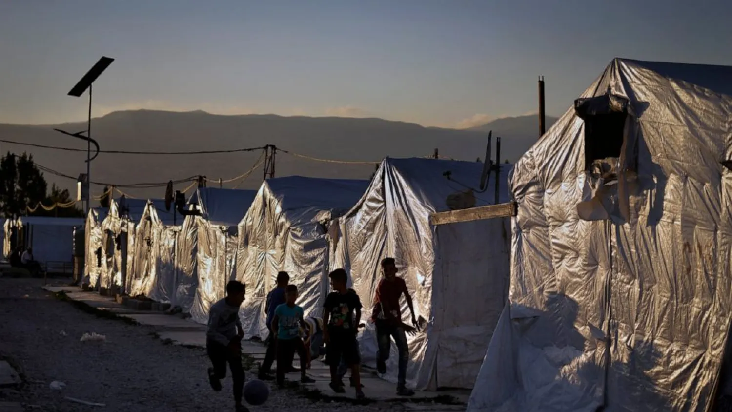 Syrian children play soccer by their tents at a refugee camp in the town of Bar Elias in the Bekaa Valley, Lebanon, July 7, 2022. (AP Photo/Bilal Hussein)
