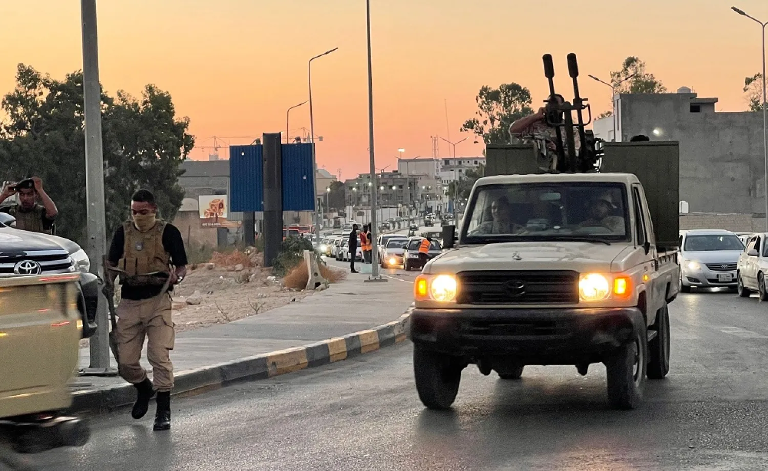 Members of the "444 Brigade" affiliated with Libya's ministry of defense man positions in the area of an overnight gunbattle in Tripoli's suburb of Ain Zara, on July 22, 2022. (AFP)