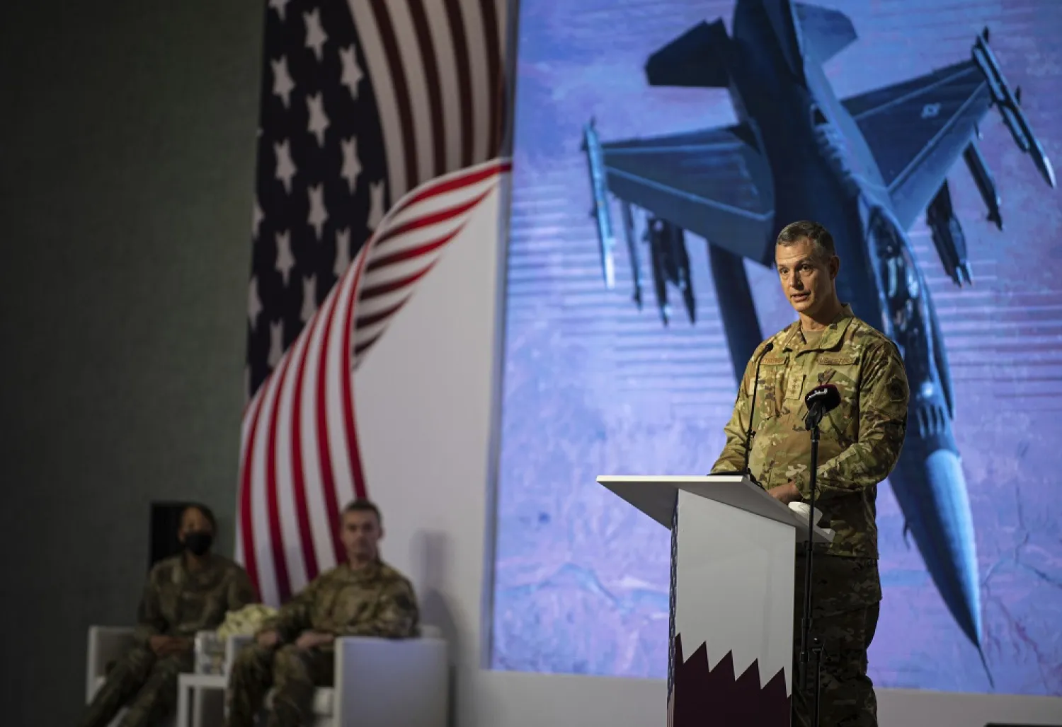 In this photo provided by the US Air Force, US Air Force Lt. Gen. Alexus G. Grynkewich, incoming Ninth Air Force (Air Forces Central) commander, delivers a commemorative speech during a change of command ceremony at Al Udeid Air Base, Qatar, Thursday, July 21, 2022. (US Air Force via AP) 
