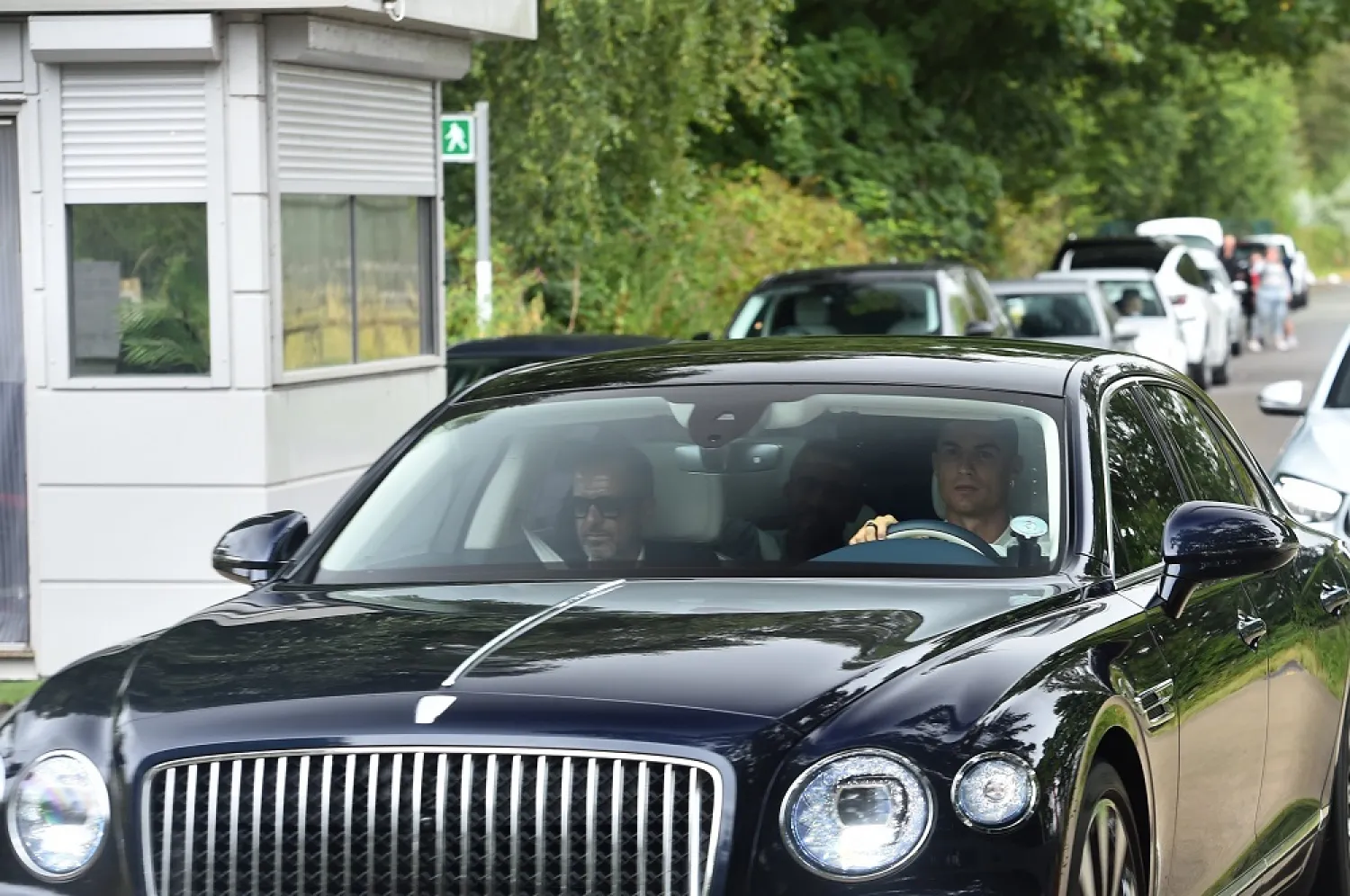 26 July 2022, United Kingdom, Manchester: Manchester United's Cristiano Ronaldo arrives in a car at Carrington Training Ground ahead of a pre-season training session for the team. (dpa)