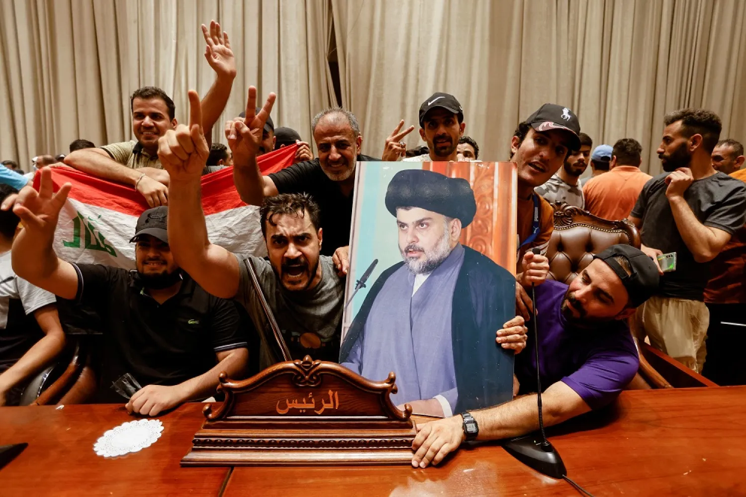 Supporters of Iraqi Shiite cleric Moqtada al-Sadr react as they protest against corruption inside the parliament building in Baghdad, Iraq July 27, 2022. (Reuters)