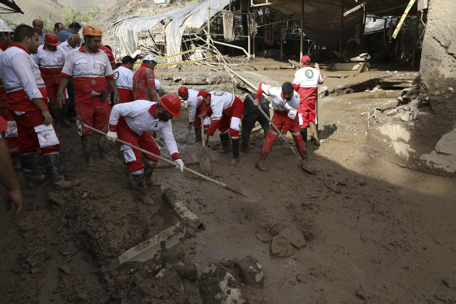 Rescue workers clean up mud after flash flooding at Imamzadeh Davood village in the northwestern part of Tehran, Iran, Thursday, July 28, 2022. (AP Photo/Vahid Salemi)