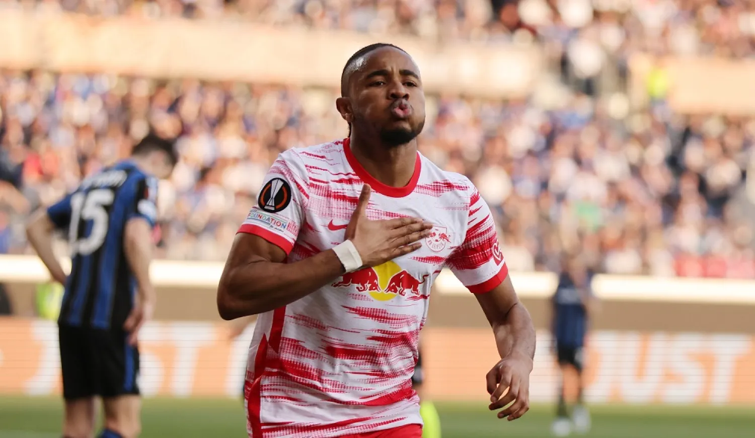 14 April 2022, Italy, Bergamo: RB Leipzig's Christopher Nkunku celebrates scoring his side's first goal during the UEFA Europa League quarter-final, second leg match between Atalanta BC and RB Leipzig at Gewiss Stadium. (dpa)