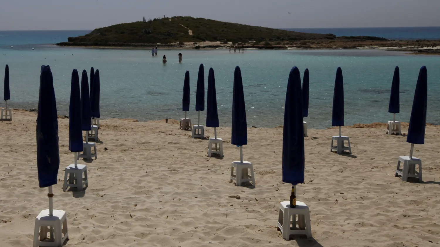 Hoping to draw tourists to Cyprus this summer, officials cite the "open-air lifestyle, abundance of personal space" and clean air. Petros Karadjias/AP