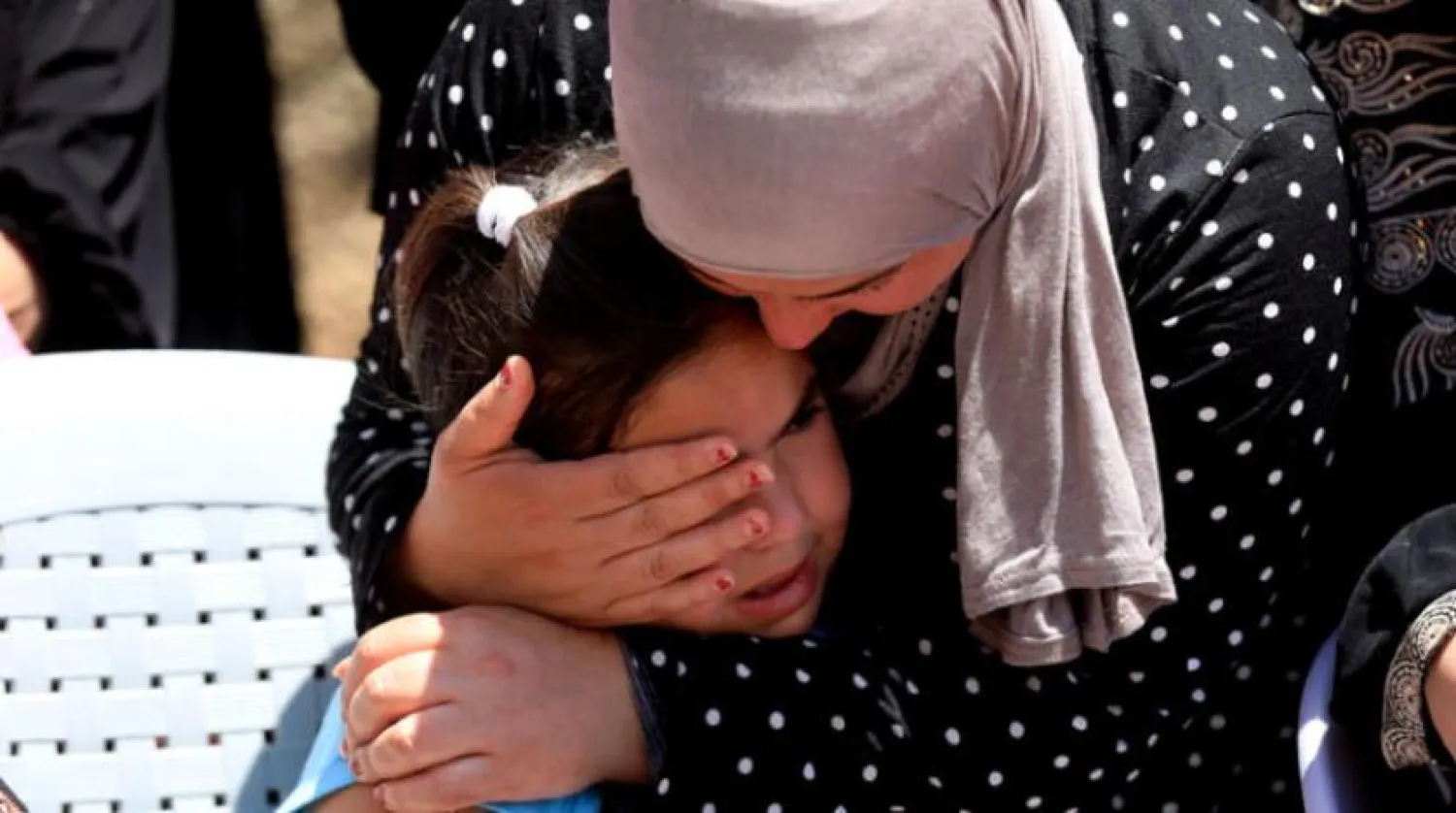 Signs of sadness and grief among relatives of Amjad Abu Alia during his funeral in al-Mughayyir town, north of Ramallah on Saturday, July 30, 2022. (EPA)
