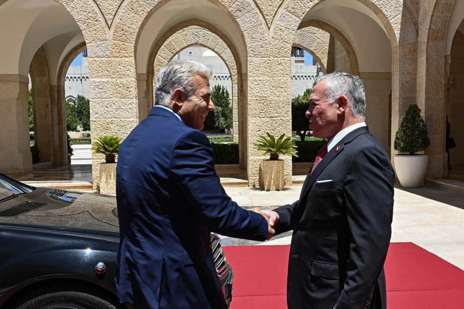 27 July 2022, Jordan, Amman: Jordanian King Abdullah II (R) receives Israeli Prime Minister Yair Lapid prior to their meeting at Amman's Royal Palace. (Haim Zach/GPO/dpa)