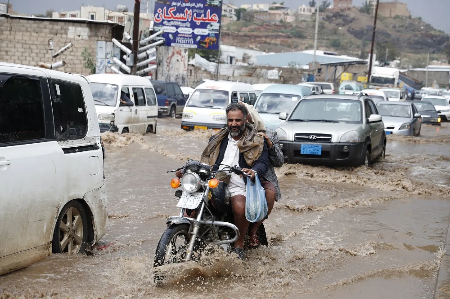A Yemeni motorcyclist drives through a flooded street following a heavy rainfall in Sana'a, Yemen, 01 August 2022. (EPA)