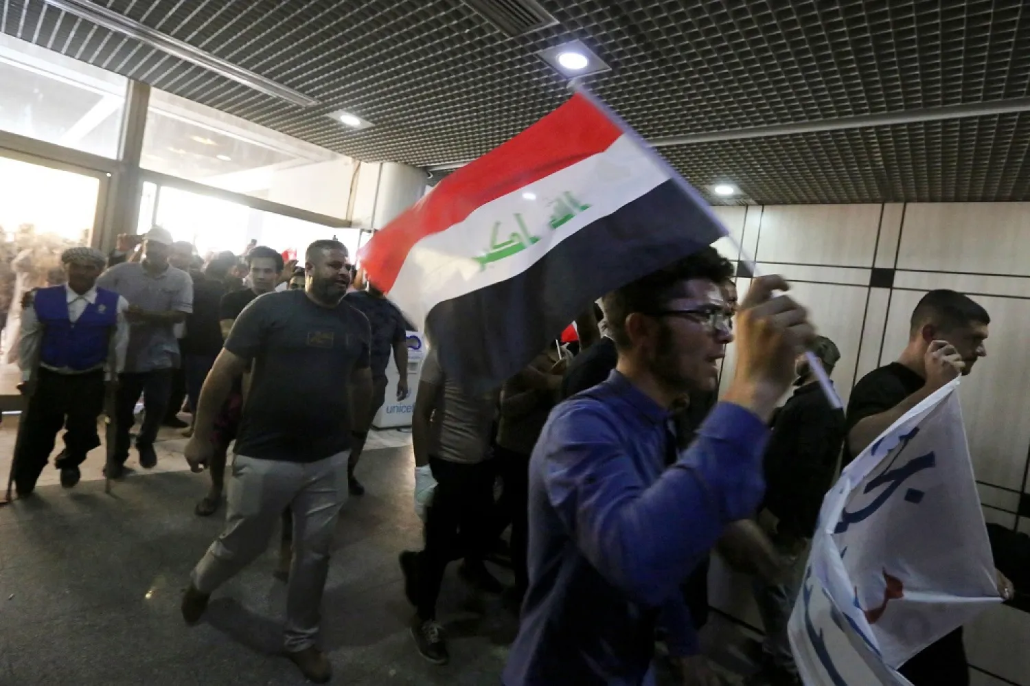 Supporters of Iraqi cleric Moqtada al-Sadr chant slogans during their sit-in at Iraq's parliament to protest a rival bloc's nomination for prime minister, in the capital Baghdad's high-security Green Zone, on August 2, 2022. (AFP)