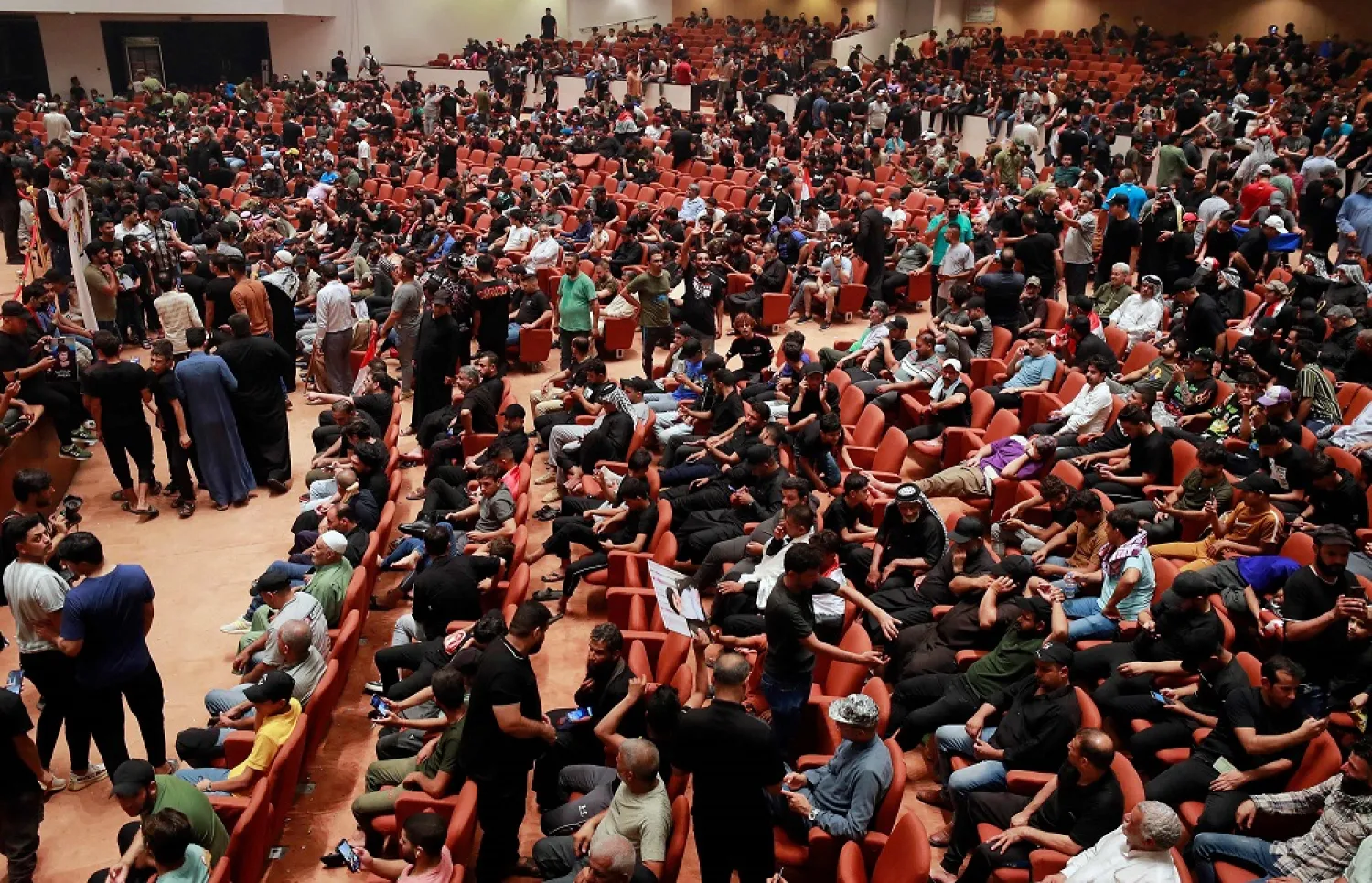 Supporters of Iraqi cleric Moqtada al-Sadr, protesting against a rival bloc's nomination for prime minister, gather at the constitutional hall as they continue their sit-in inside Iraq's parliament in the capital Baghdad's high-security Green Zone, on August 2, 2022. (AFP)