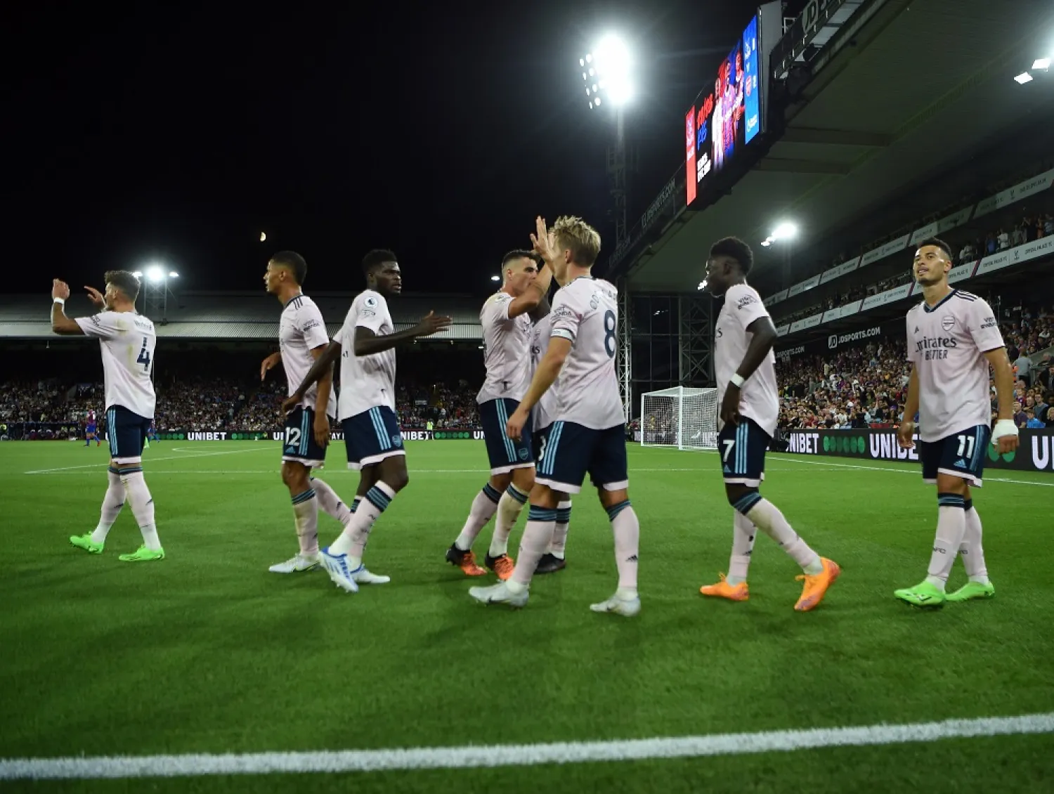 Arsenal players celebrate after Crystal Palace's Marc Guehi (not pictured) scores the 0-2 own goal during the English Premier League match between Crystal Palace and Arsenal FC in London, Britain, 05 August 2022. (EPA)
