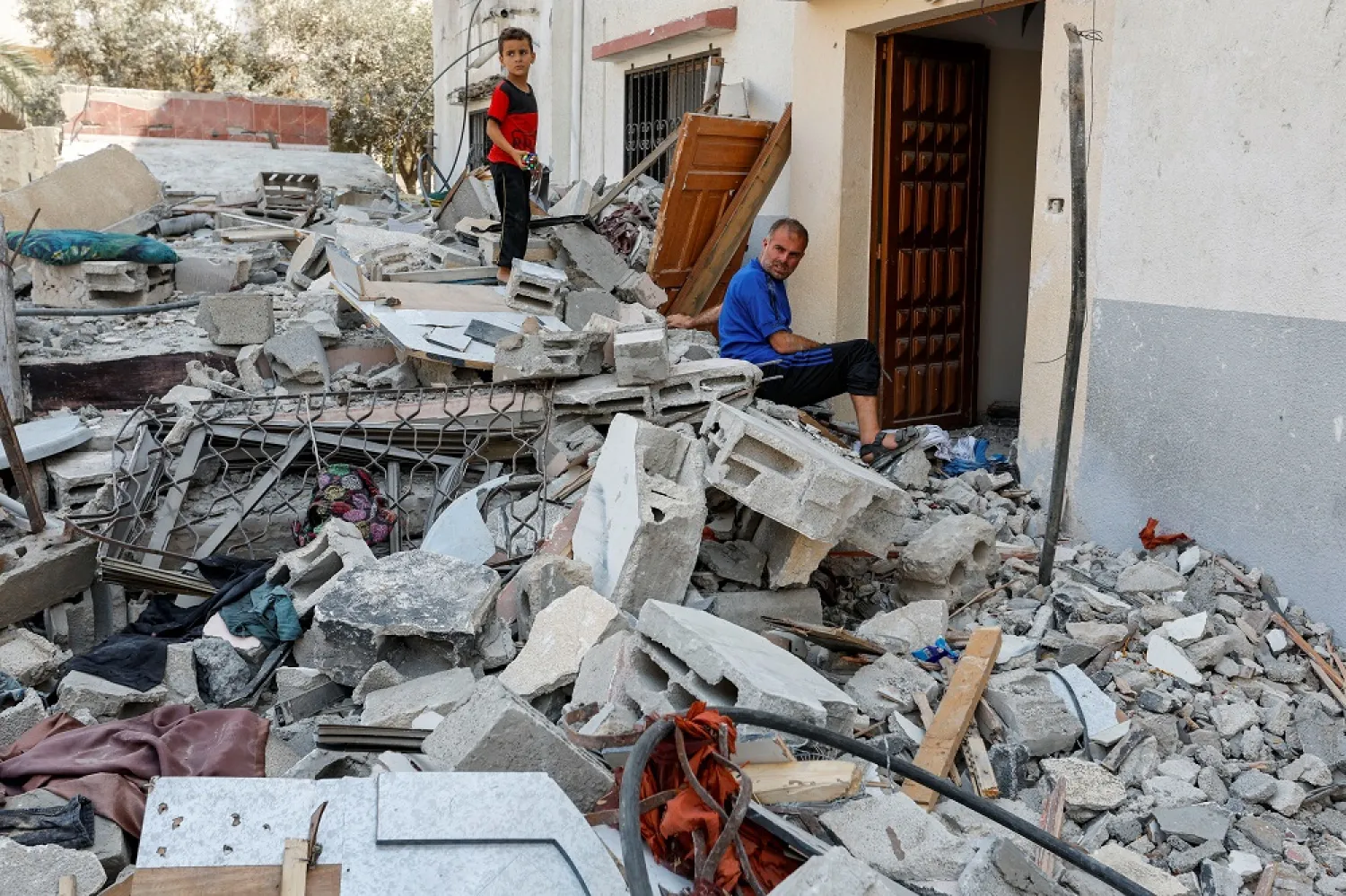 Hesham, one of four disabled Palestinian siblings from Shamalakh family, sits at the rubble of their home after it was destroyed in an Israeli air strike, amid Israel-Gaza fighting, in Gaza City August 6, 2022. (Reuters)