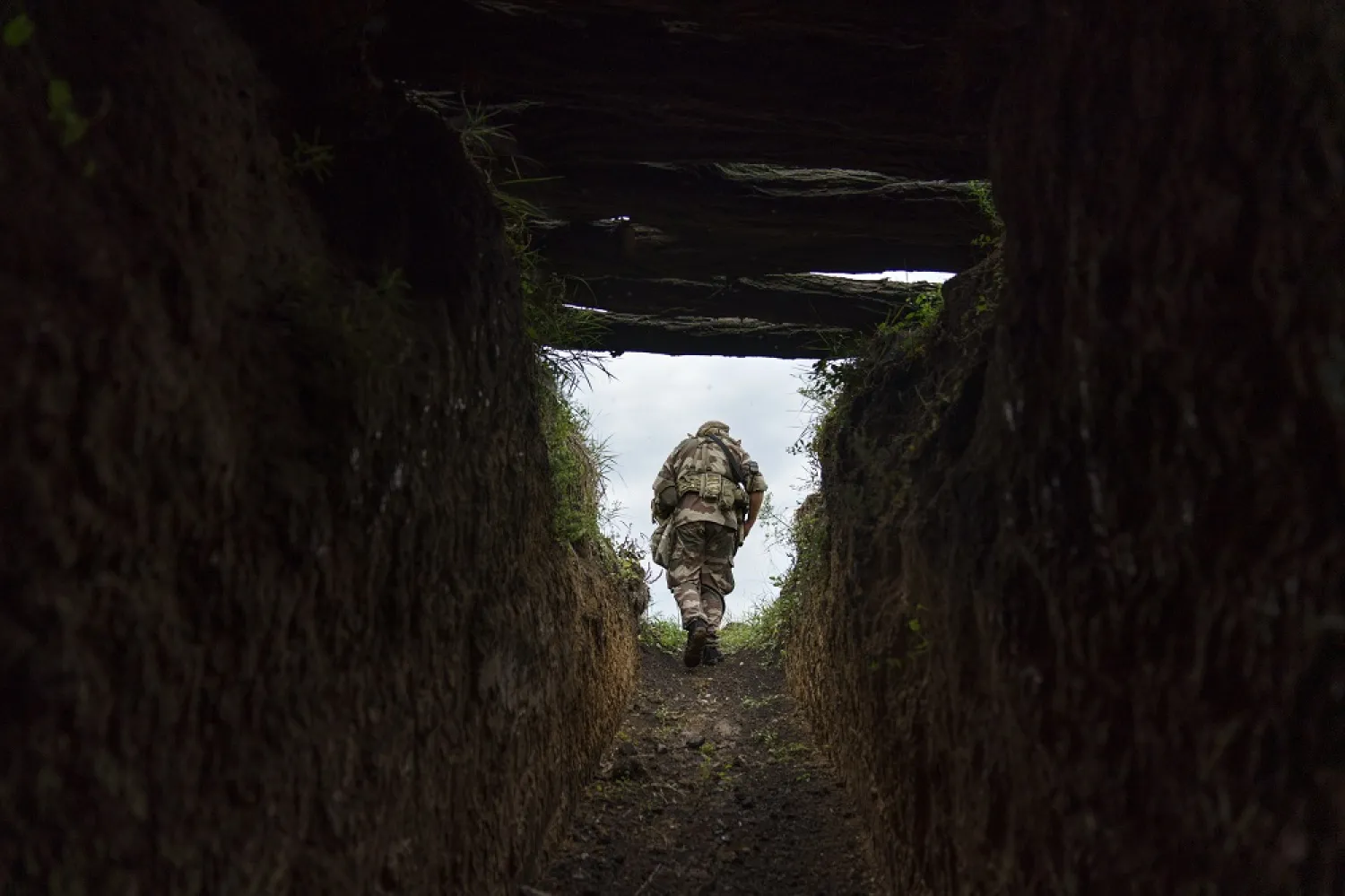Sgt. Maj. Artur Shevtsov with the Dnipro-1 regiment exits a bunker at the unit's position near Sloviansk, Donetsk region, eastern Ukraine, Friday, Aug. 5, 2022. (AP)
