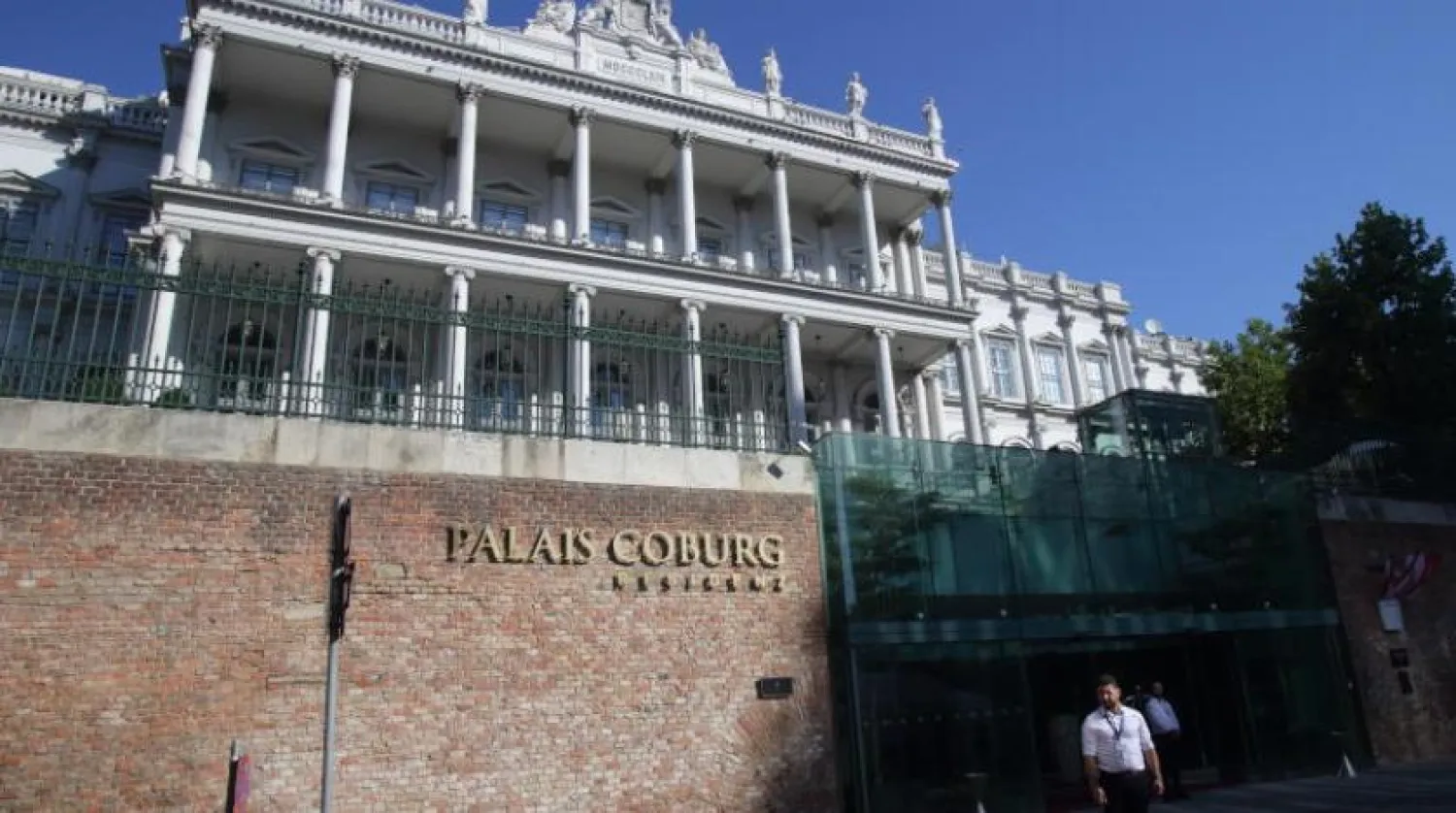 Two men in front of the nuclear negotiations headquarters at the Palais Coburg in Vienna (AFP)
