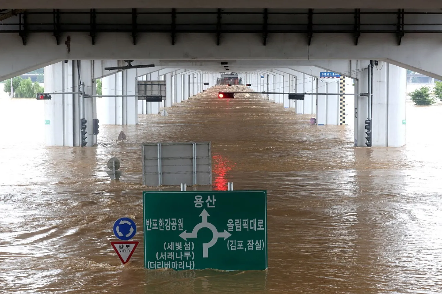 A bridge is submerged by torrential rain of the previous day at Han river in Seoul, South Korea, August 9, 2022. (Yonhap via Reuters)