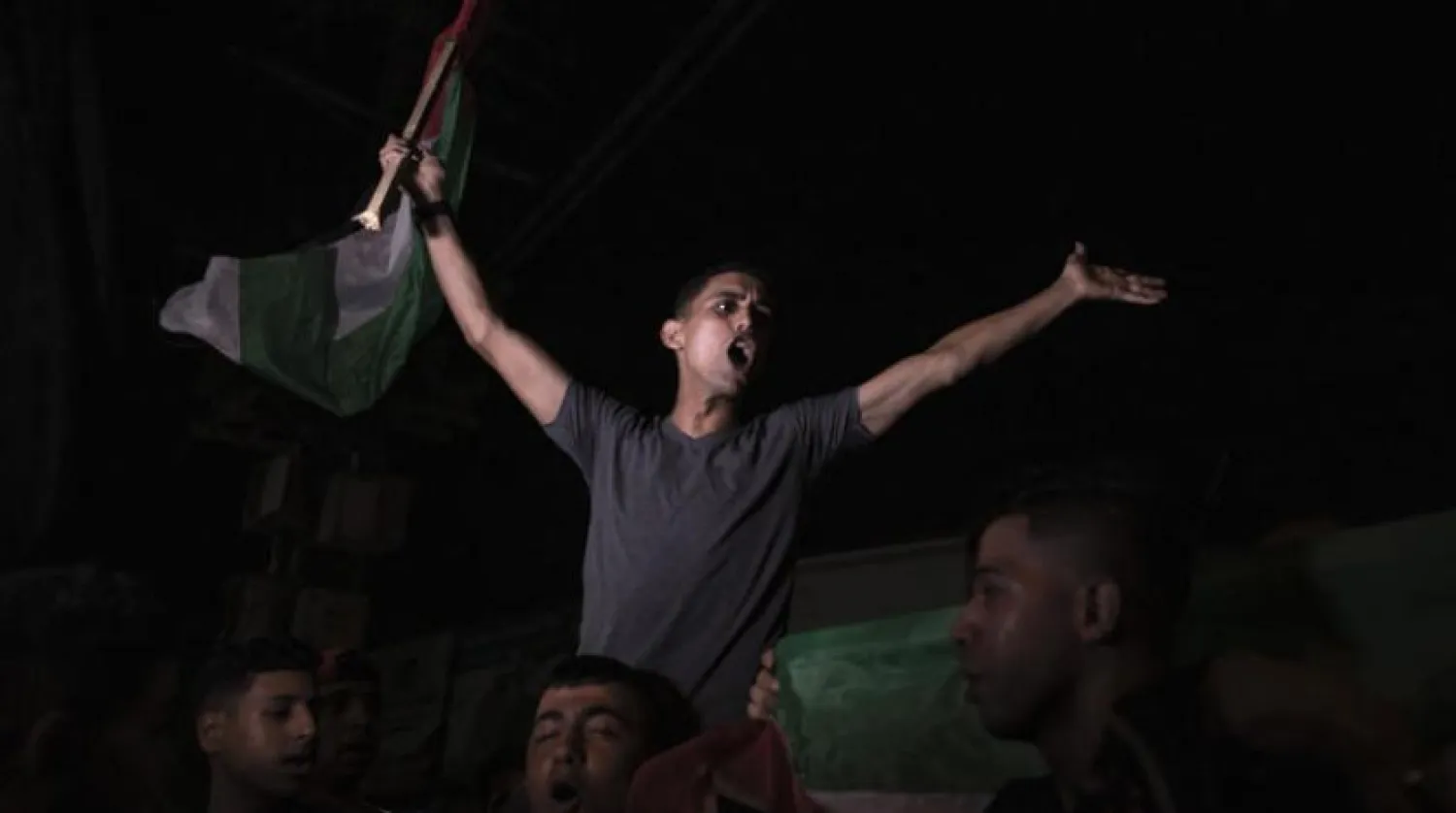 Palestinians celebrate the ceasefire agreement in Gaza City early Monday (AFP)
