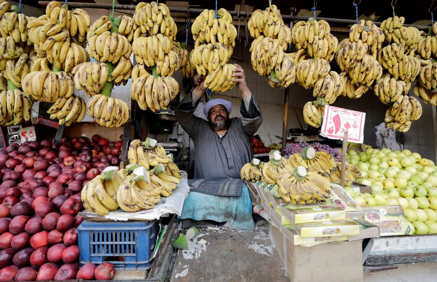 An Egyptian fruits seller works at a market in Cairo, Egypt, March 22, 2022. (Reuters)