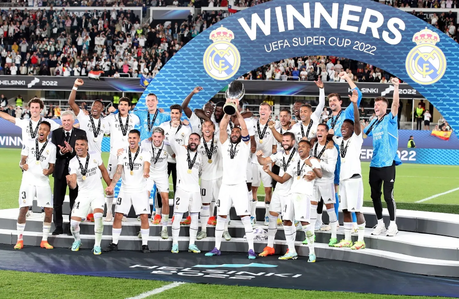 Karim Benzema of Real Madrid (C) lifts the trophy as players celebrate after winning the UEFA Super Cup match between Real Madrid and Eintracht Frankfurt at the Olympic Stadium in Helsinki, Finland, 10 August 2022. (EPA)
