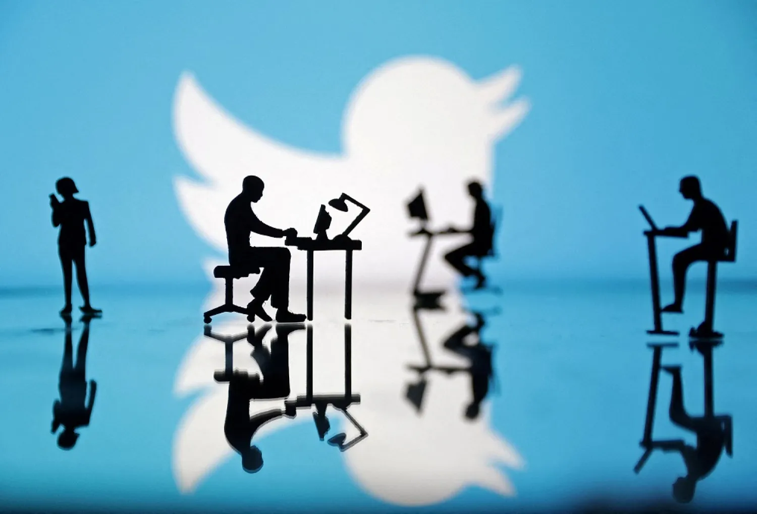  Figurines with computers and smartphones are seen in front of Twitter logo in this illustration, July 24, 2022. (Reuters)