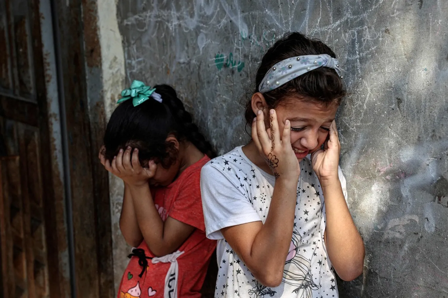 Friends react during the funeral of Palestinian child Lian al-Shaer, after she succumbed to her injuries sustained in last week's Israeli air strikes, in Khan Younis in the southern Gaza Strip, on August 11, 2022. (AFP)