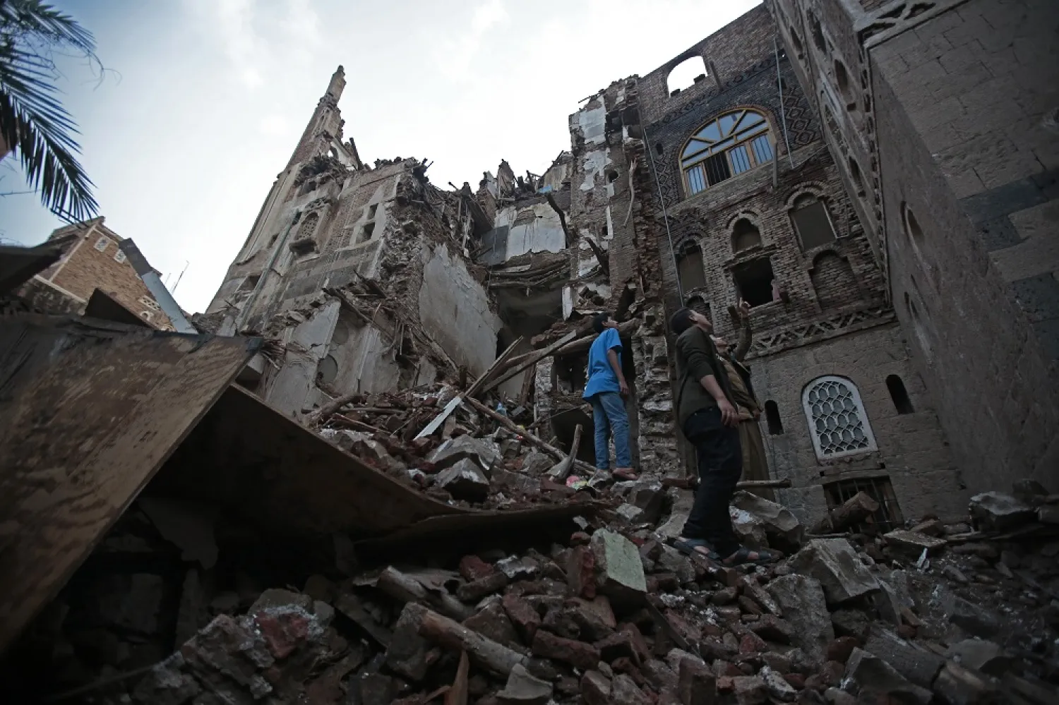 Yemeni people inspect a rains-collapsed UNESCO-listed building in the old city of Sanaa, Yemen, Wednesday, Aug 10, 2022. (AP)
