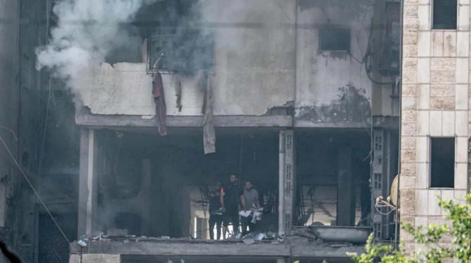 Smoke rises from a building after Israeli raids on Gaza on Friday (AFP)