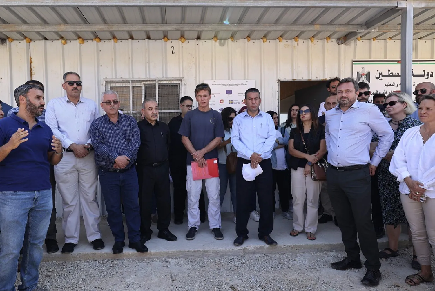 Sven Kuhn von Burgsdorff (C), the head of the European Union's mission to the West Bank and the Gaza Strip, stands during a visit with a number of consuls of European countries at a Bedouin school in the Palestinian village of Ain Samiya, east of Ramallah in the central occupied West Bank, which is subject to demolition by the Israeli army, on August 12, 2022. (AFP)
