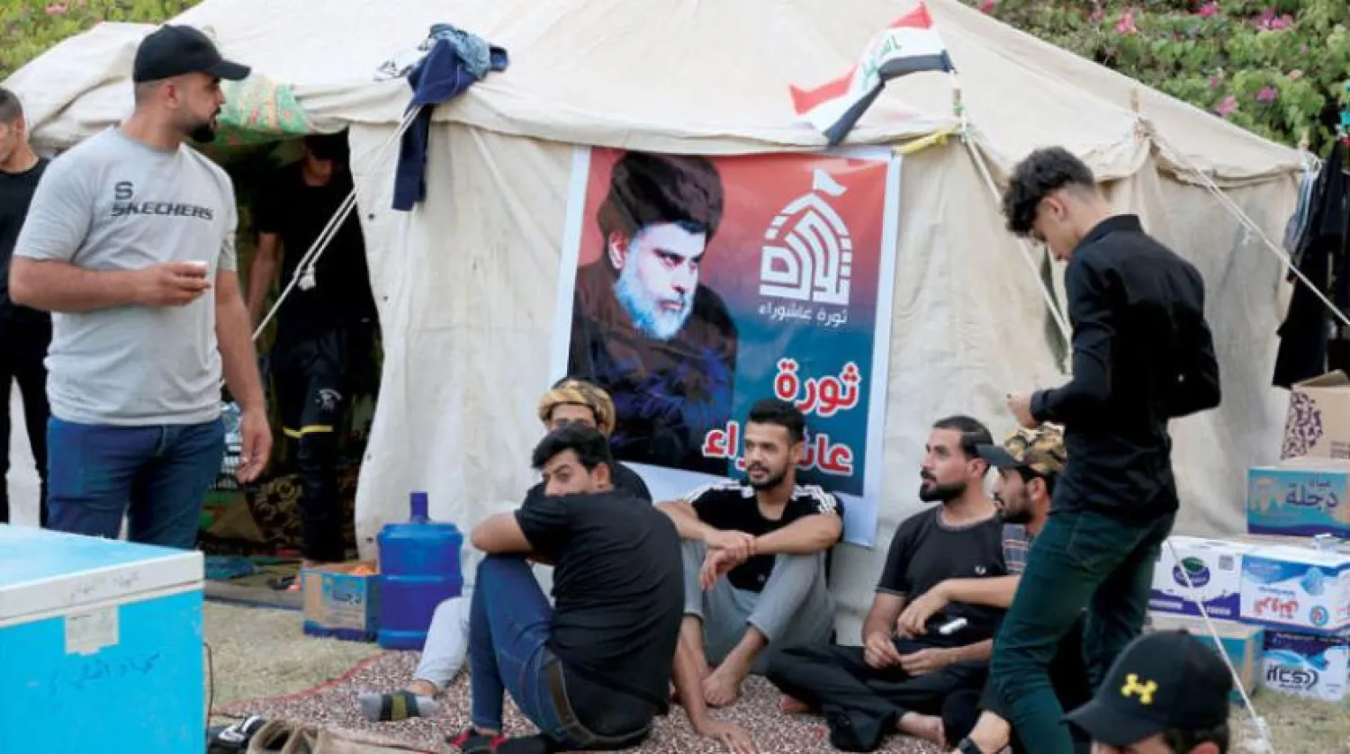  Al-Sadr’s supporters sit next to the tents in front of the Iraqi parliament building in Baghdad. (EPA)
