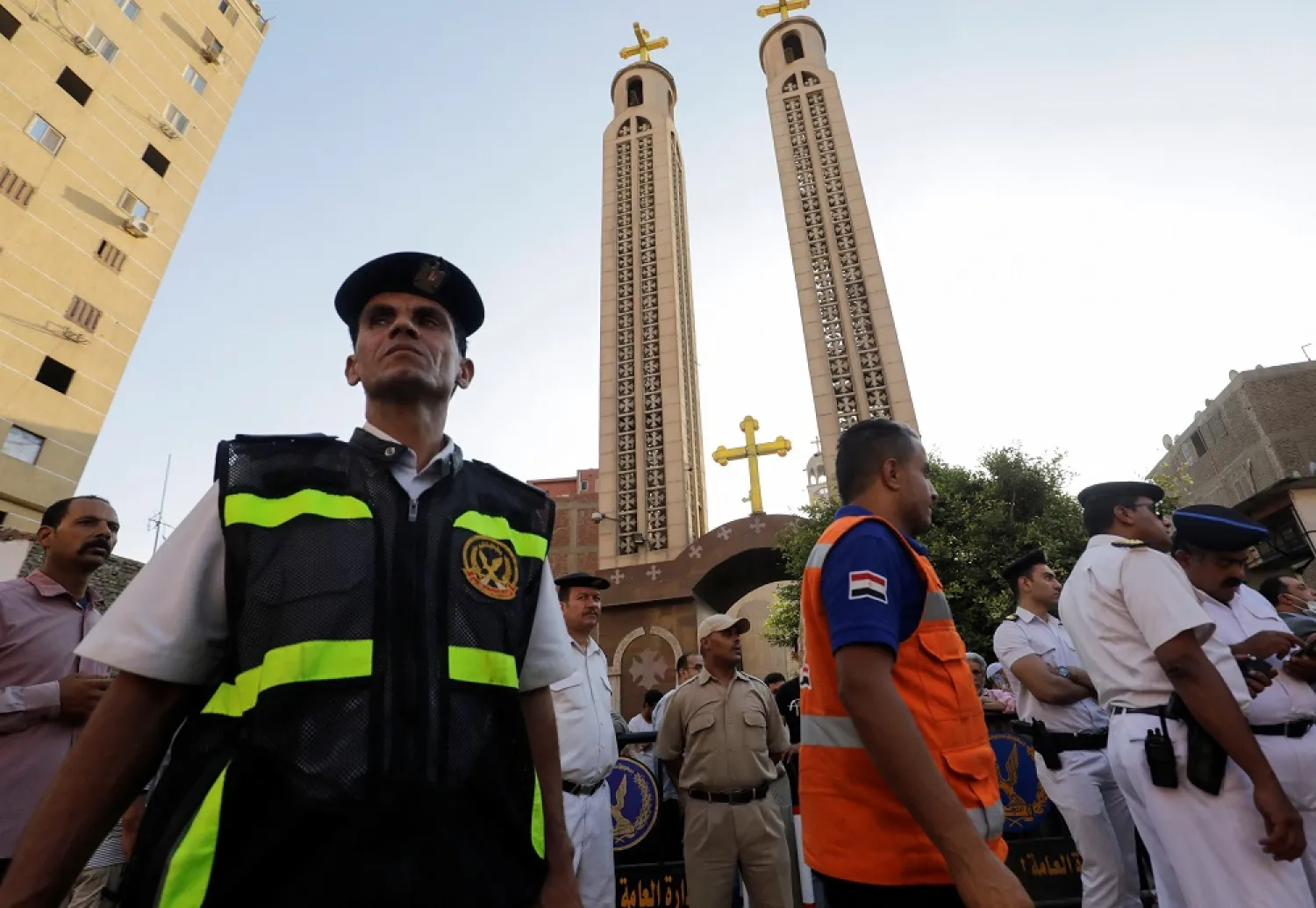 Police men stand during the funeral of victims, who died due to the fire that broke out at the Abu Sifin church, outside the Church of the Blessed Virgin Mary at Warraq Al Arab district in Giza Governorate, Egypt, August 14, 2022. (Reuters)
