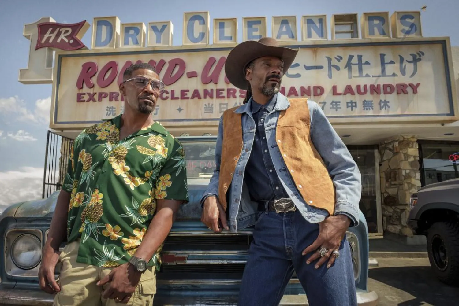 This image released by Netflix shows Jamie Foxx, left, and Snoop Dogg in a scene from "Day Shift." (Netflix via AP)